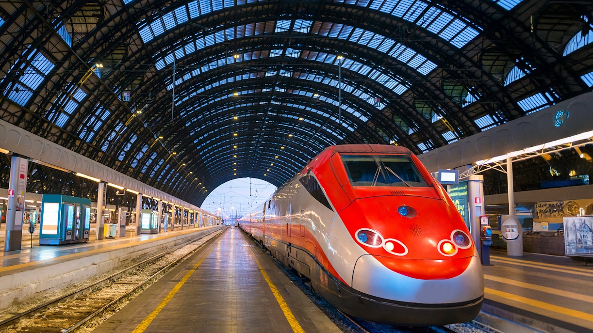 Trenitalia train at dusk in Milan's railroad station.