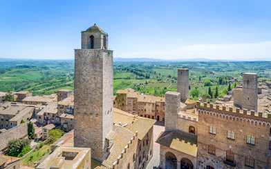 Aerial view of San Gimignano towers and surrounding Tuscan countryside.