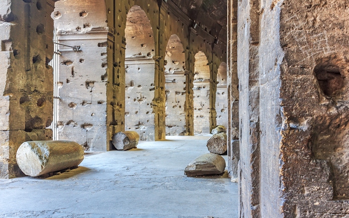 Colosseum underground passage with ancient stone columns in Rome, Italy.
