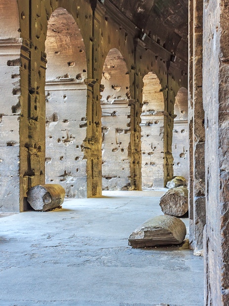 Colosseum underground passage with ancient stone columns in Rome, Italy.