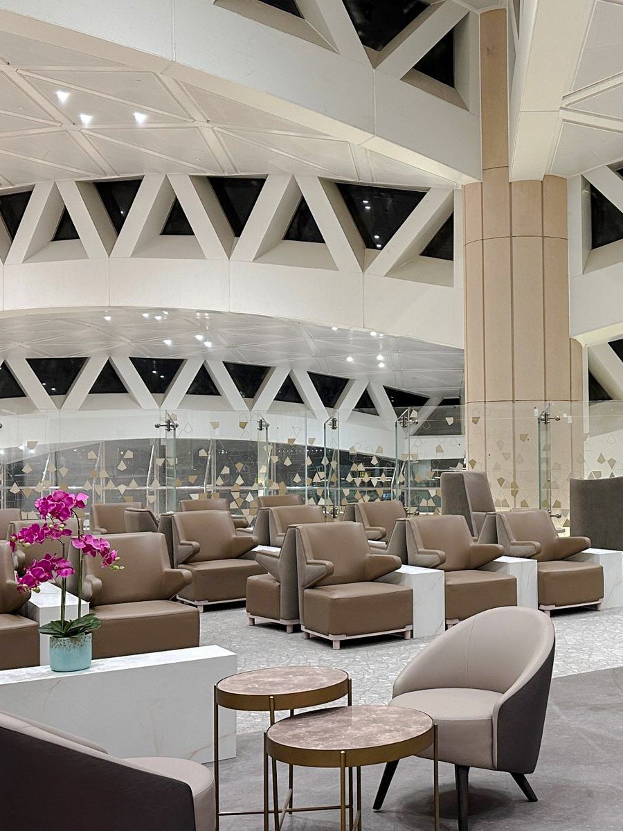 Plaza Premium Lounge seating area with modern chairs and tables, Riyadh airport.
