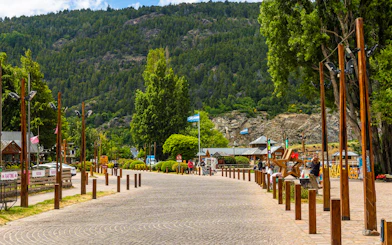 Promenade along the waterfront with flags and shops in San Martín de los Andes.