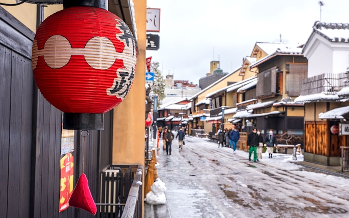 Red lantern in snowy Kyoto street near Kiyomizu Temple area.