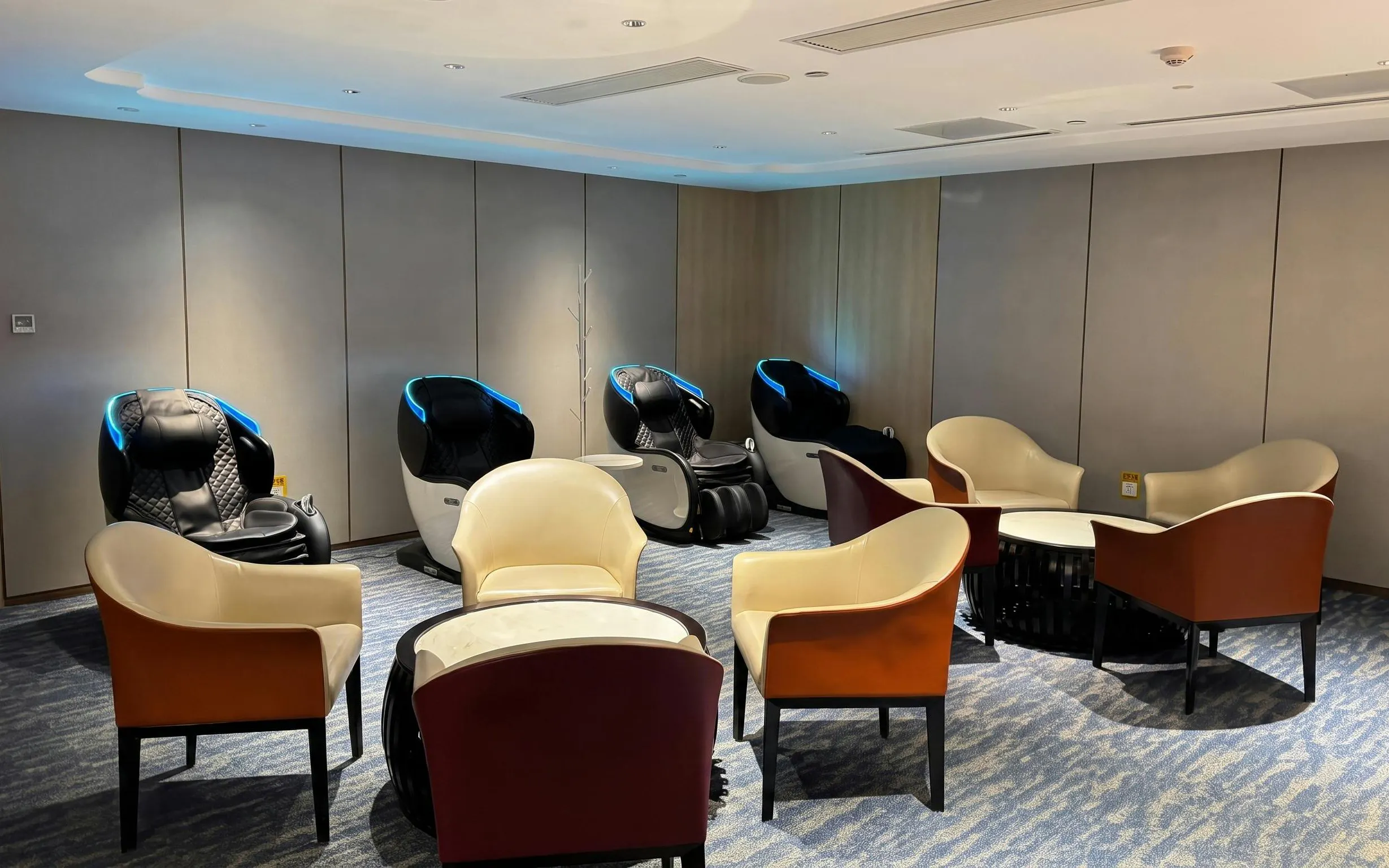 Massage chairs and seating area in CHUM Guest 79 Lounge, Daxing International Airport.
