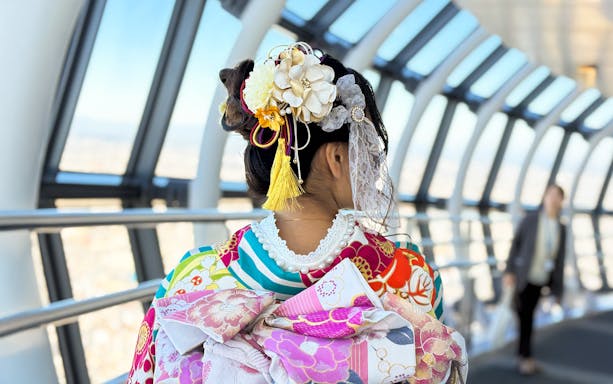 Woman in kimono on Tokyo Skytree observation deck.