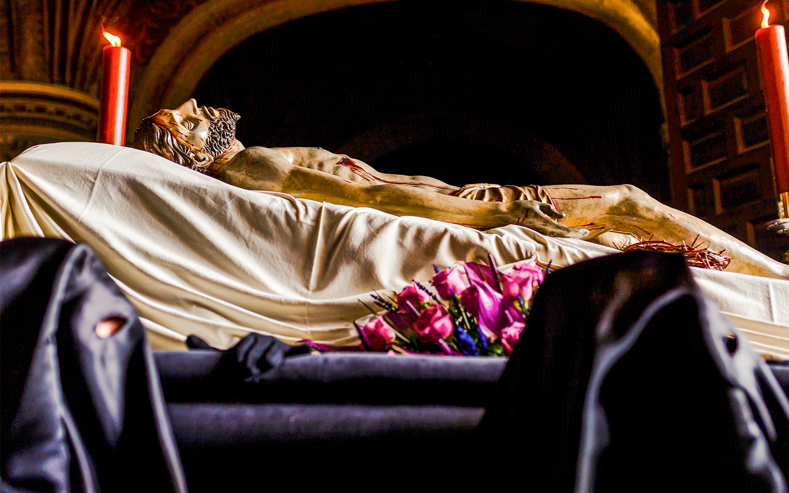 Holy Week procession in Naples with Nazarenes carrying Christ's body.