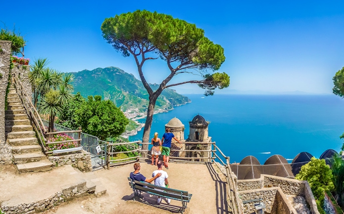 Terrace view of Amalfi Coast from Ravello with tourists and Mediterranean Sea.