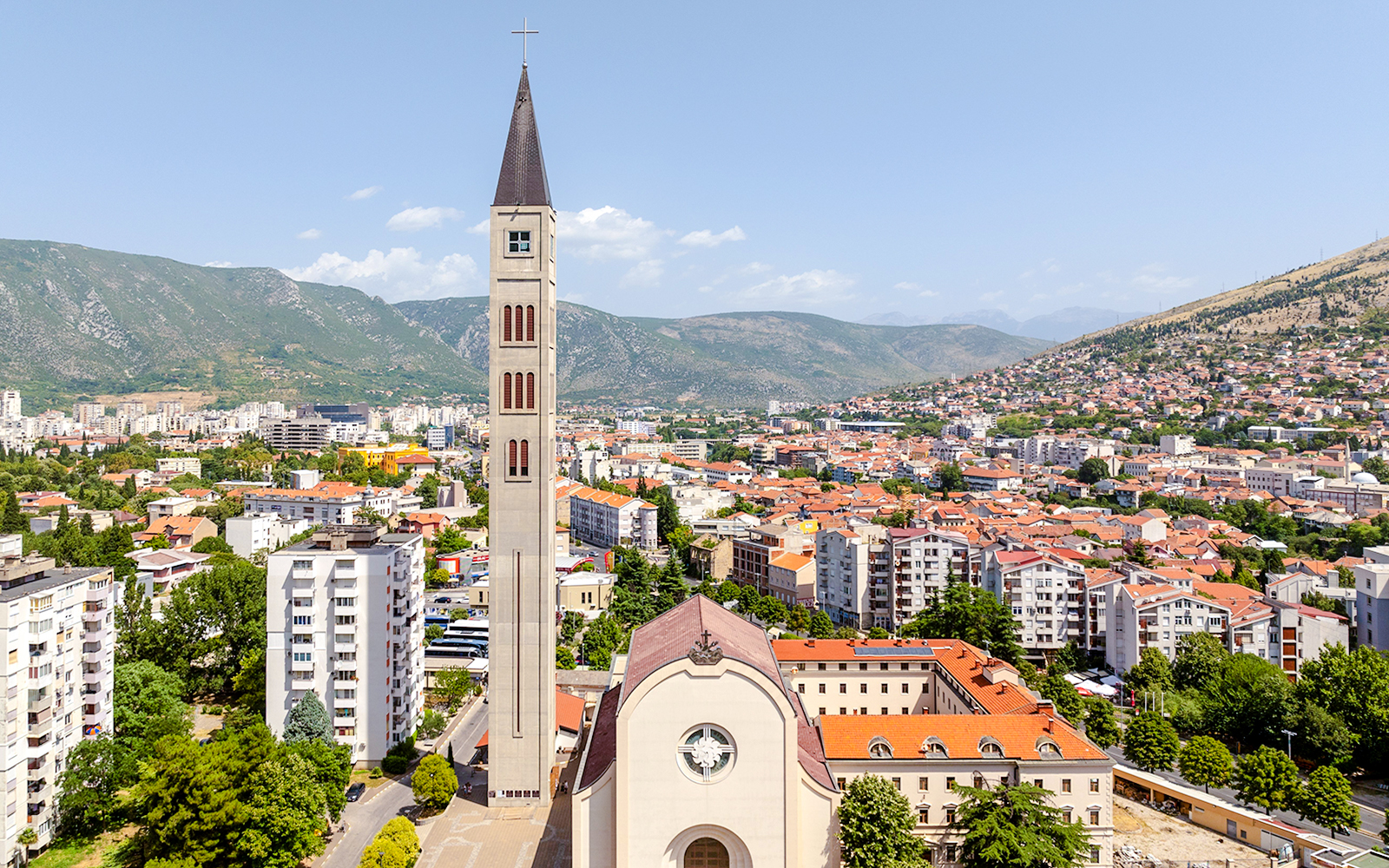 Franciscan Church and Monastery of St. Peter and Paul with Mostar cityscape, Bosnia.