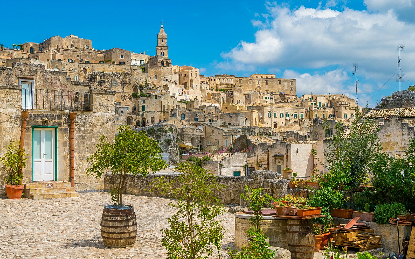Sassi of Matera stone buildings and courtyard on a sunny day, Italy.