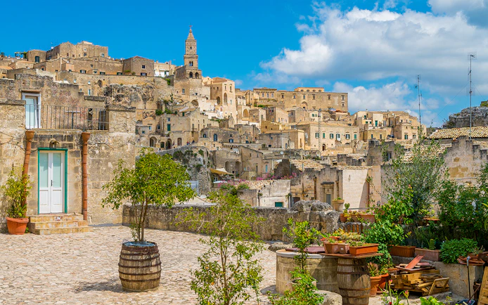 Sassi of Matera stone buildings and courtyard on a sunny day, Italy.
