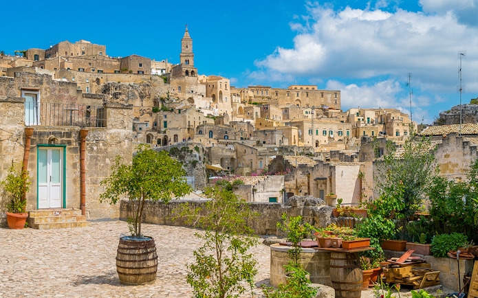 Sassi of Matera stone buildings and courtyard on a sunny day, Italy.