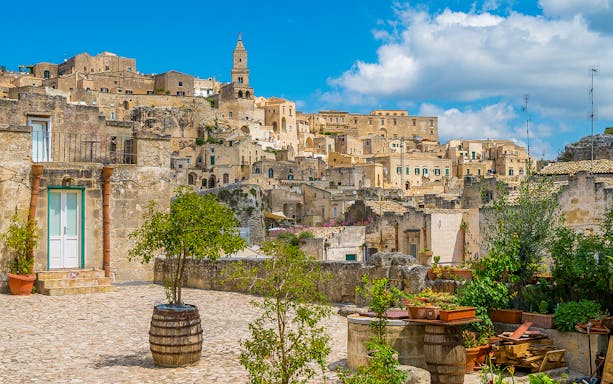 Sassi of Matera stone buildings and courtyard on a sunny day, Italy.