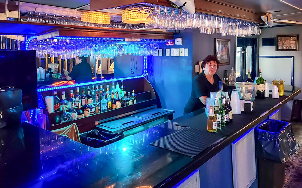 Bar area inside NYC Skyline and Statue of Liberty Harbor Lights Night Cruise.