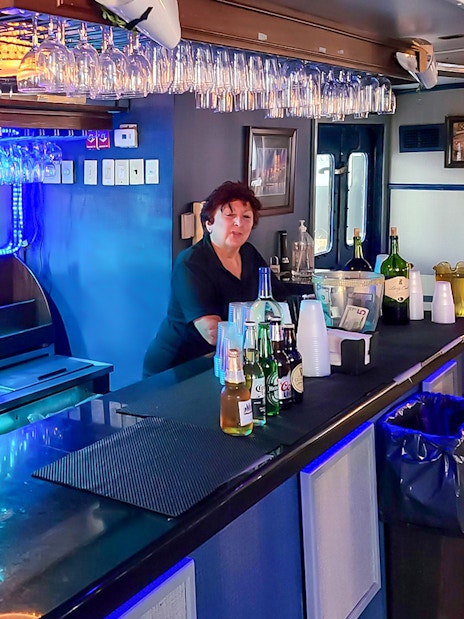 Bar area inside NYC Skyline and Statue of Liberty Harbor Lights Night Cruise.
