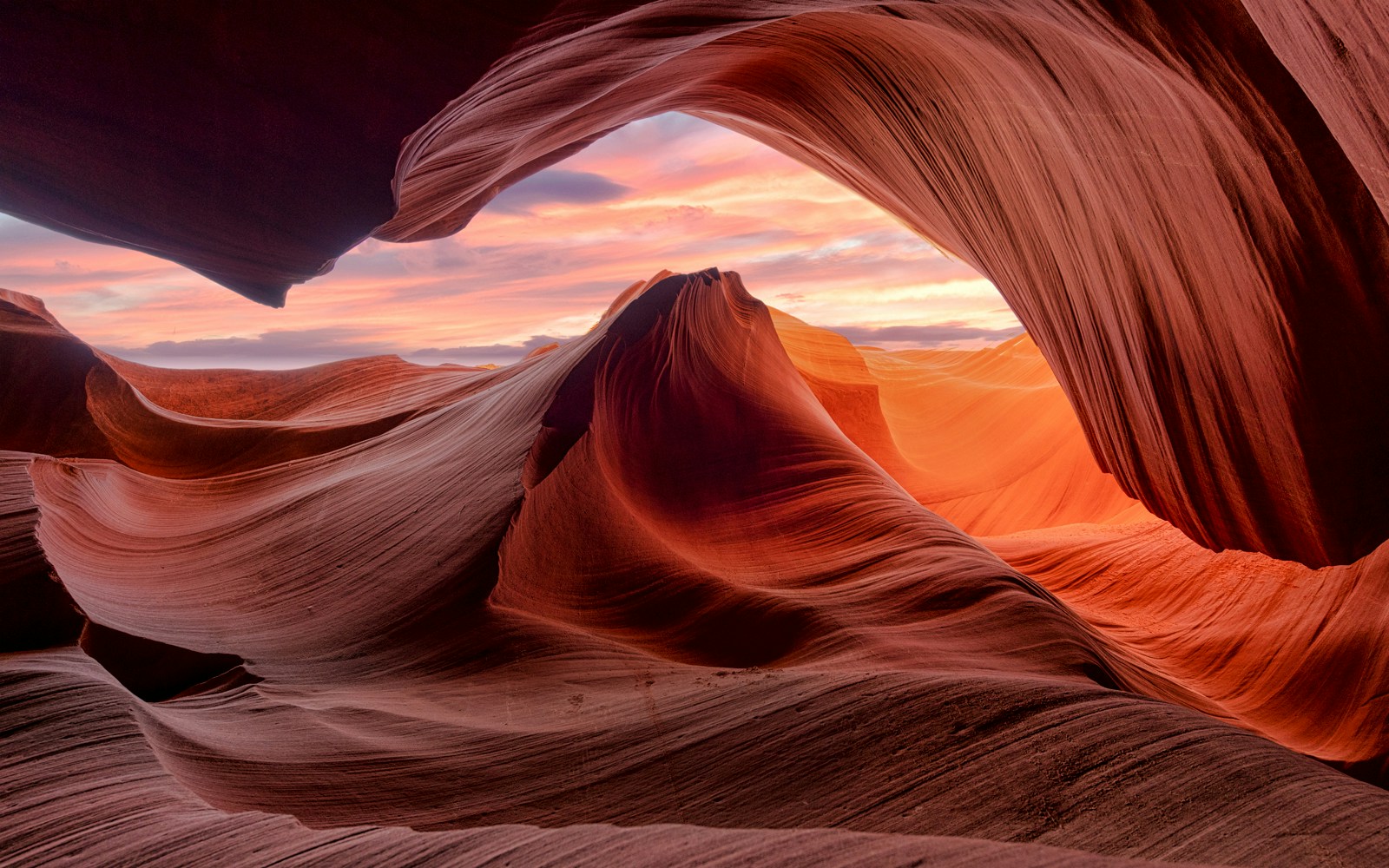 Antelope Canyon's swirling sandstone formations at sunset in Arizona.