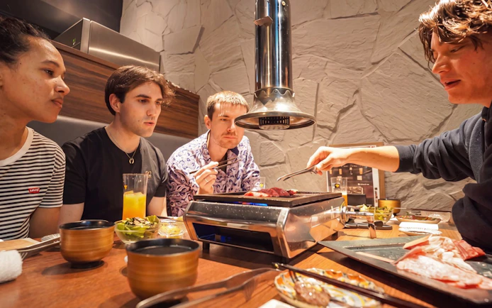 Guests enjoying a Tokyo Omakase sushi and A5 Wagyu experience in Shinjuku restaurant.