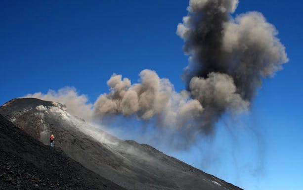 Mount Etna guided tour with cable car, showcasing volcanic landscape and trekking path.