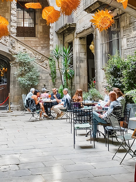 Courtyard at Palau Dalmases with people dining before a flamenco show in Barcelona.