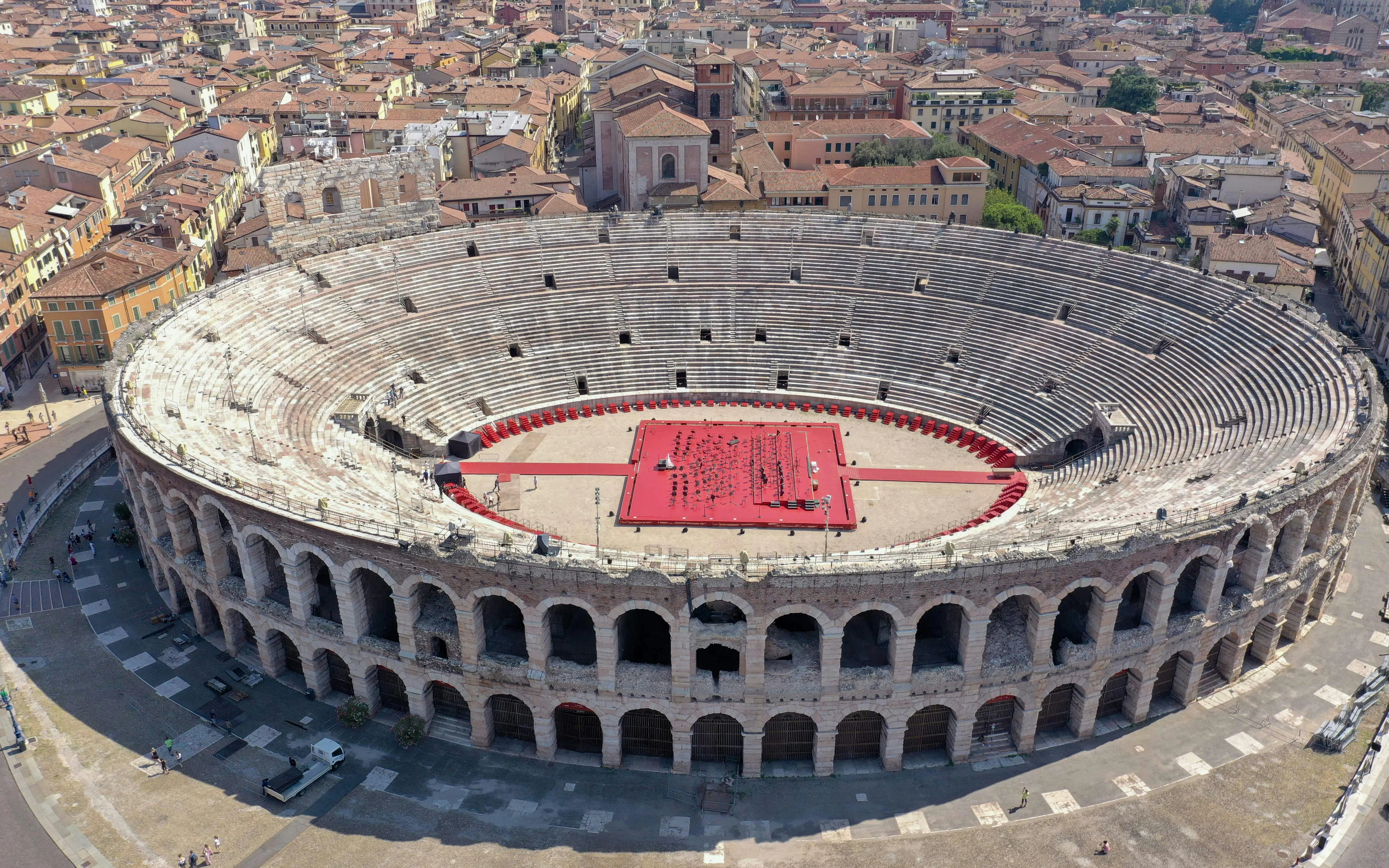 Verona Arena aerial view with red stage setup in Italy.