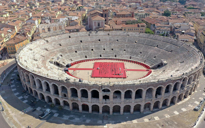Verona Arena aerial view with red stage setup in Italy.