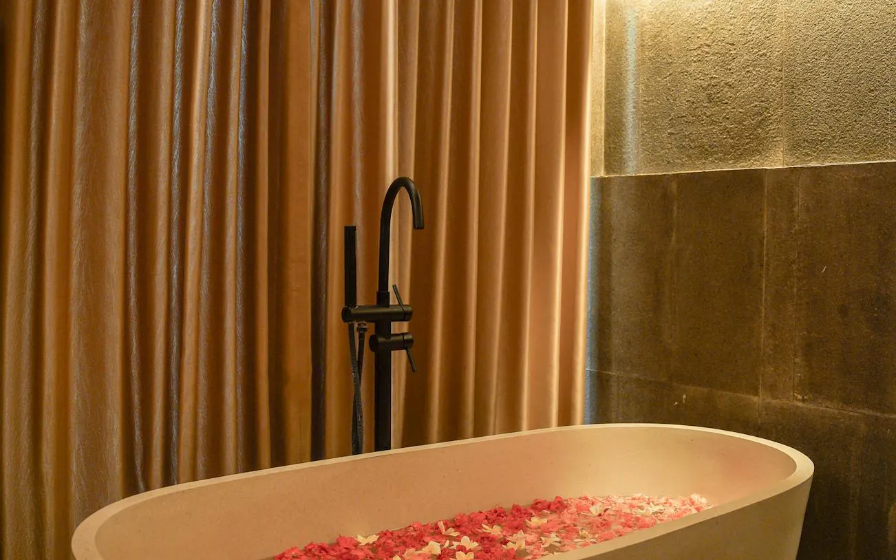 Luxurious spa bath with flower petals at Ame Spa, Bali.