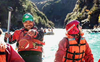 Whitewater rafters smiling on Shotover River, Queenstown adventure.