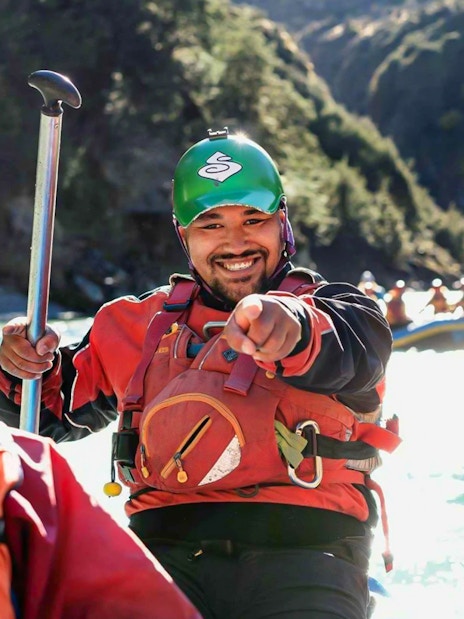 Whitewater rafters smiling on Shotover River, Queenstown adventure.