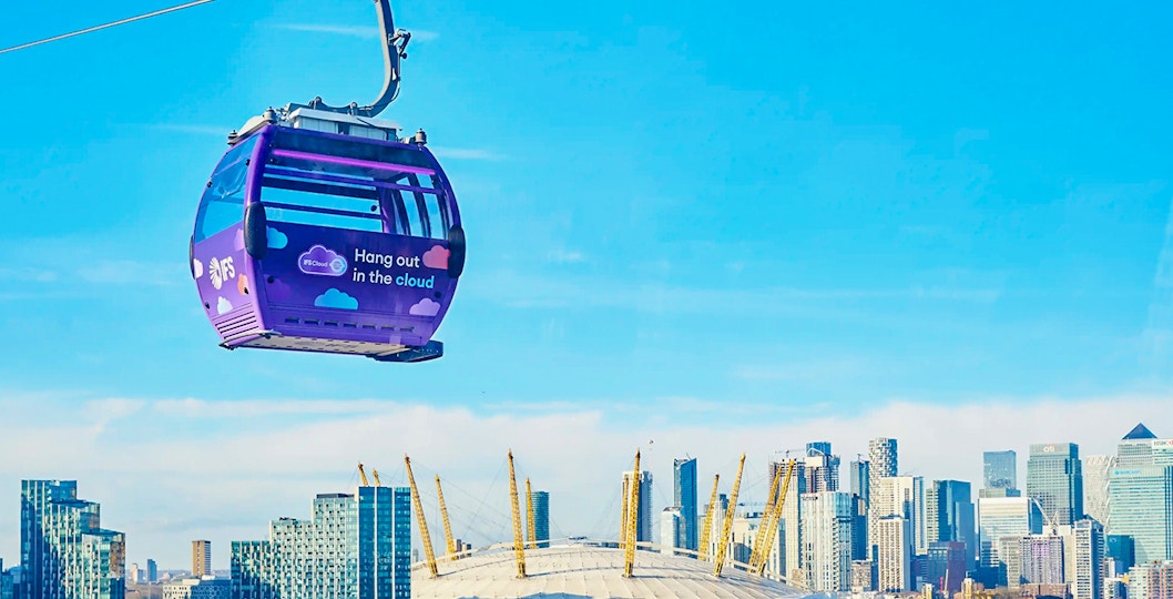 London IFS Cable Car with city skyline and O2 Arena in the background.