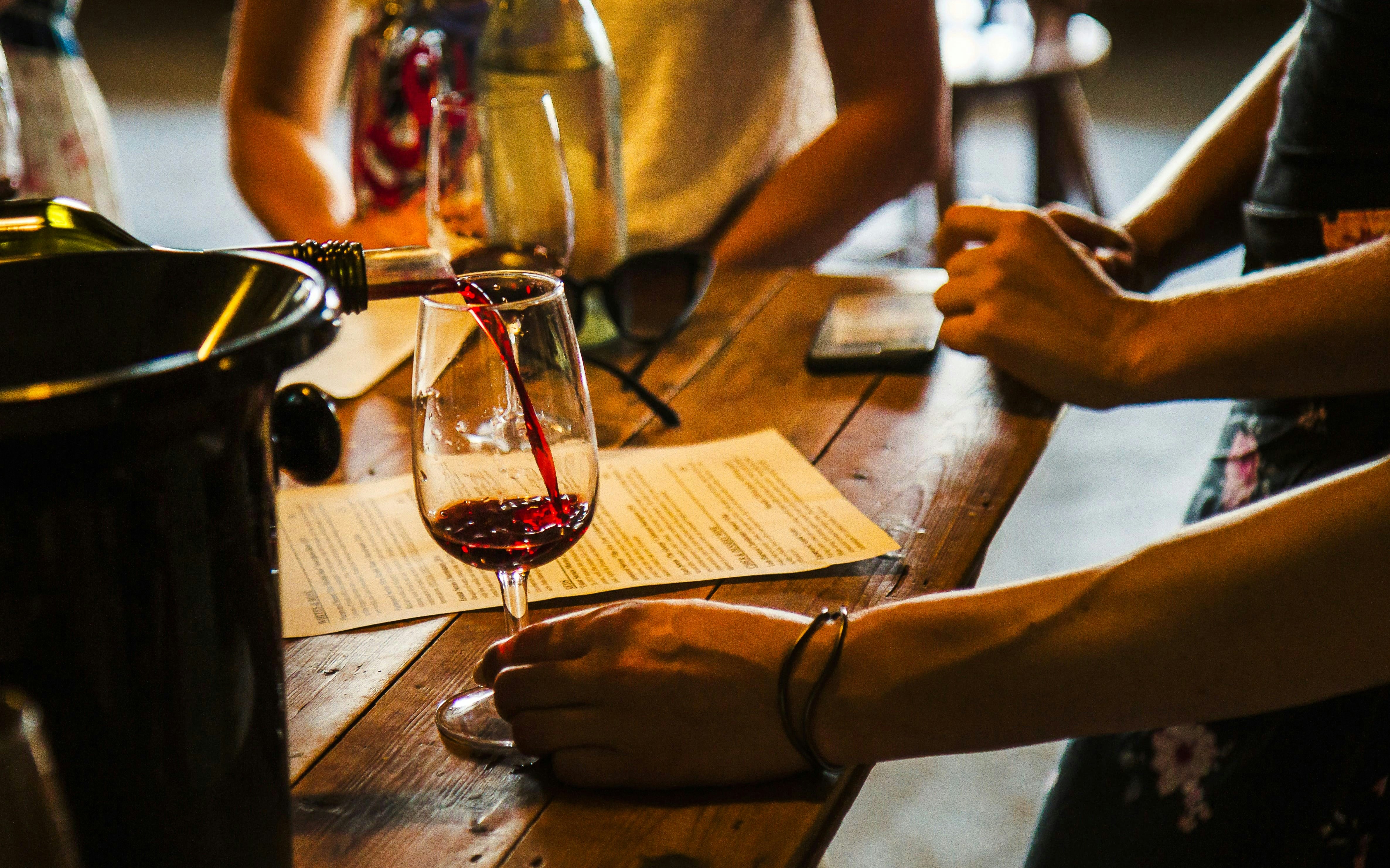 Wine being poured into a glass during a tasting in Yarra Valley.