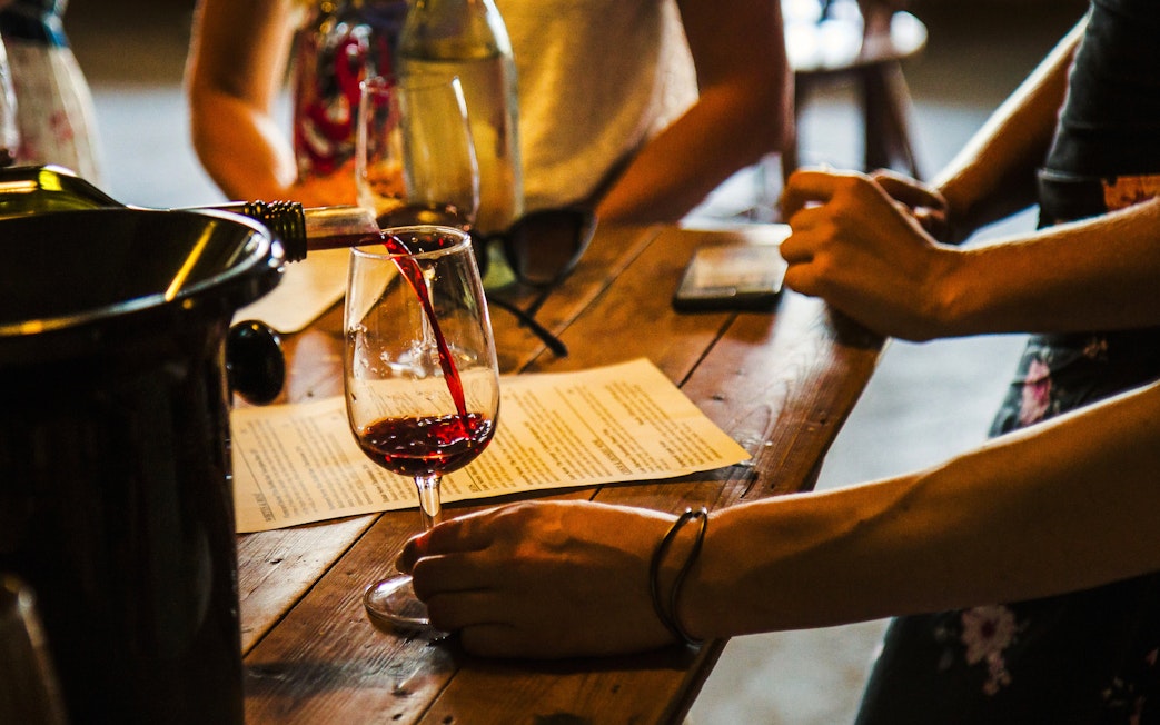 Wine being poured into a glass during a tasting in Yarra Valley.