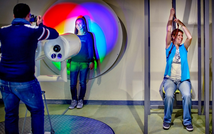 Visitors engaging with interactive exhibits at NEMO Science Museum, Amsterdam.