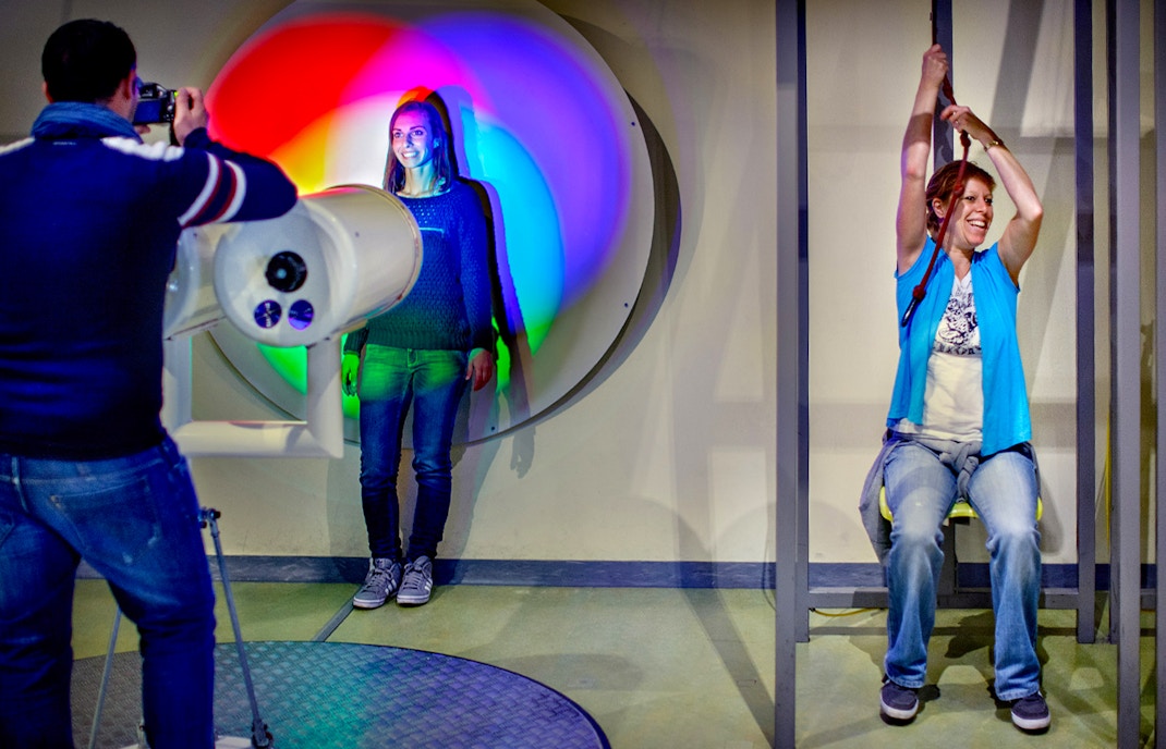 Visitors engaging with interactive exhibits at NEMO Science Museum, Amsterdam.