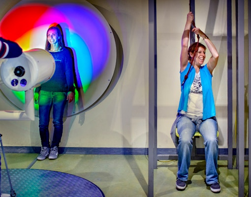 Visitors engaging with interactive exhibits at NEMO Science Museum, Amsterdam.