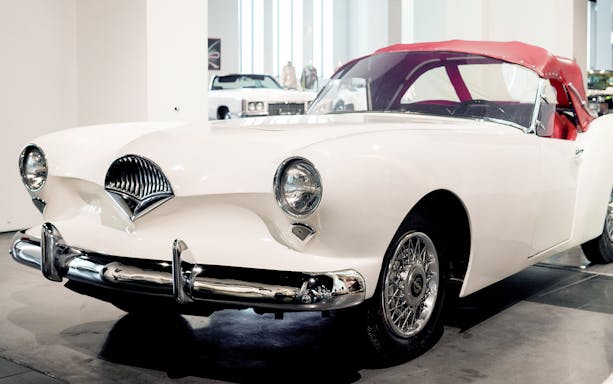 Classic white car displayed at Malaga Automobile & Fashion Museum.