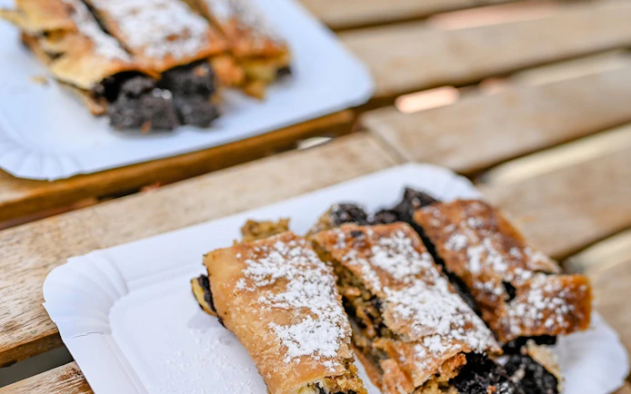 Czech pastries with powdered sugar on a plate during Prague food tour.