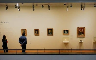 Visitors viewing art in a museum gallery.