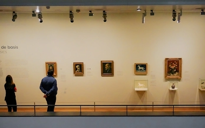 Visitors viewing art in a museum gallery.