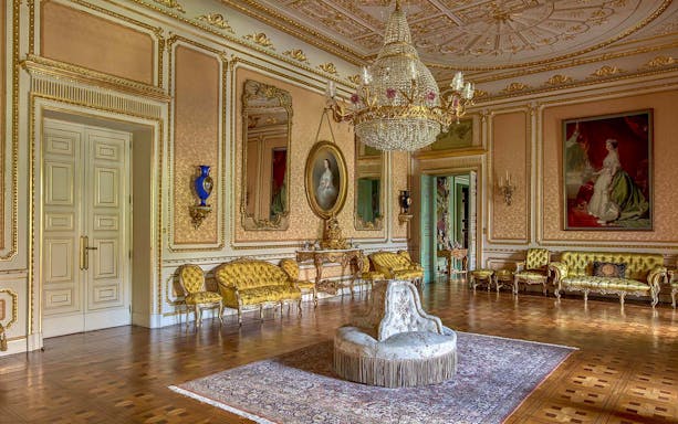 Elegant room in Liria Palace with ornate chandelier and classic furnishings.