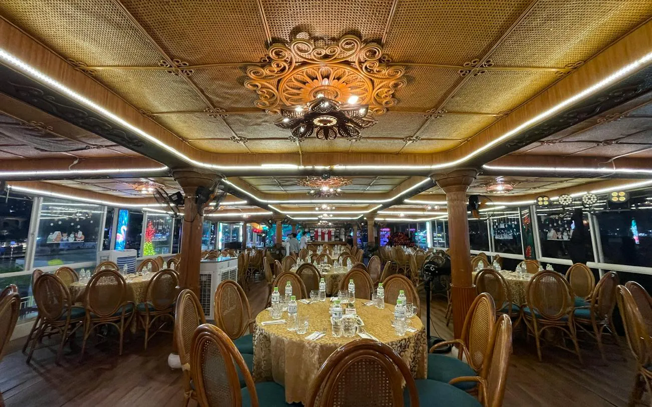 Luxurious dining setup on a Tau Rong Song Han cruise in Dubai, featuring elegant decor and table settings.