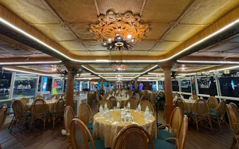 Luxurious dining setup on a Tau Rong Song Han cruise in Dubai, featuring elegant decor and table settings.