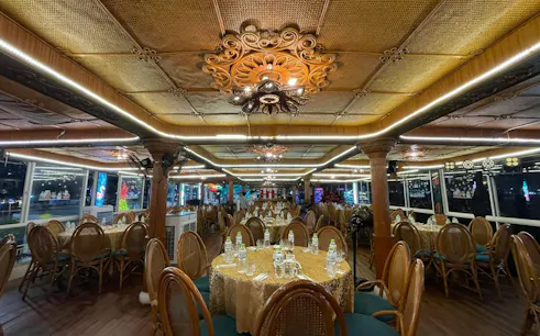 Luxurious dining setup on a Tau Rong Song Han cruise in Dubai, featuring elegant decor and table settings.