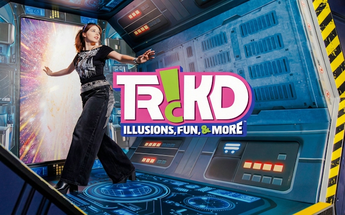 Person interacting with a space-themed illusion at TRICKD: Illusions, Fun, & More exhibit.