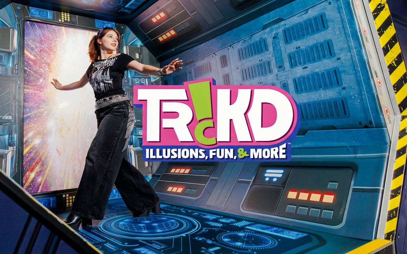 Person interacting with a space-themed illusion at TRICKD: Illusions, Fun, & More exhibit.