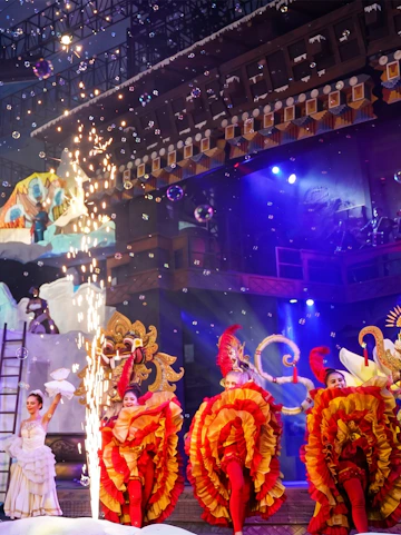 Performers in colorful costumes on stage at Trans Studio Bali.