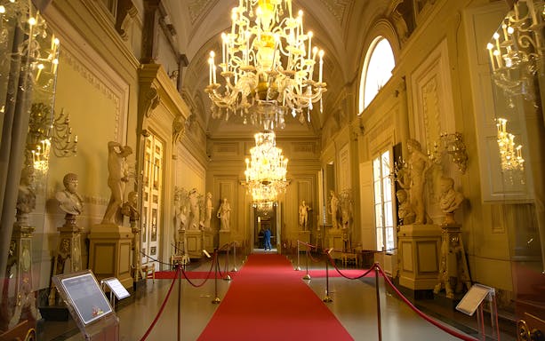Palazzo Pitti interior with chandeliers and statues, Florence.
