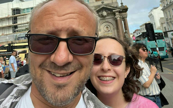 Selfie in front of Brighton city street with historic architecture in the background.