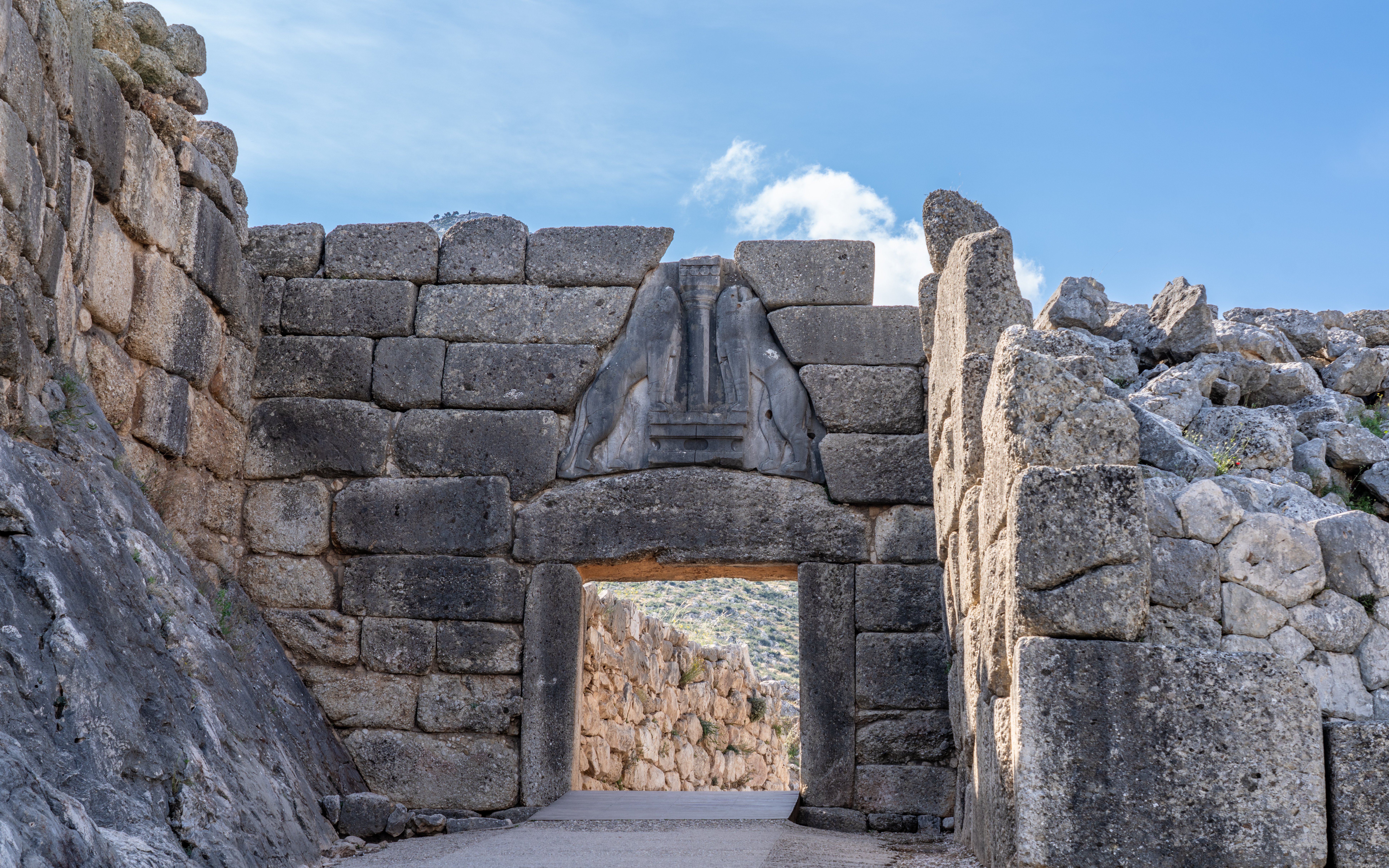 Lions Gate at Mycenaean Ruins Acropolis, Greece, featuring ancient stone architecture.