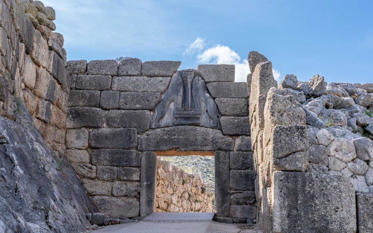 Lions Gate at Mycenaean Ruins Acropolis, Greece, featuring ancient stone architecture.