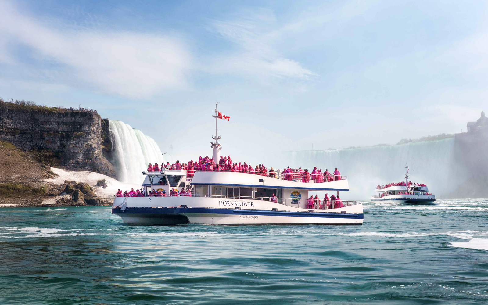 Hornblower Cruise near Niagara Falls with passengers in pink raincoats.
