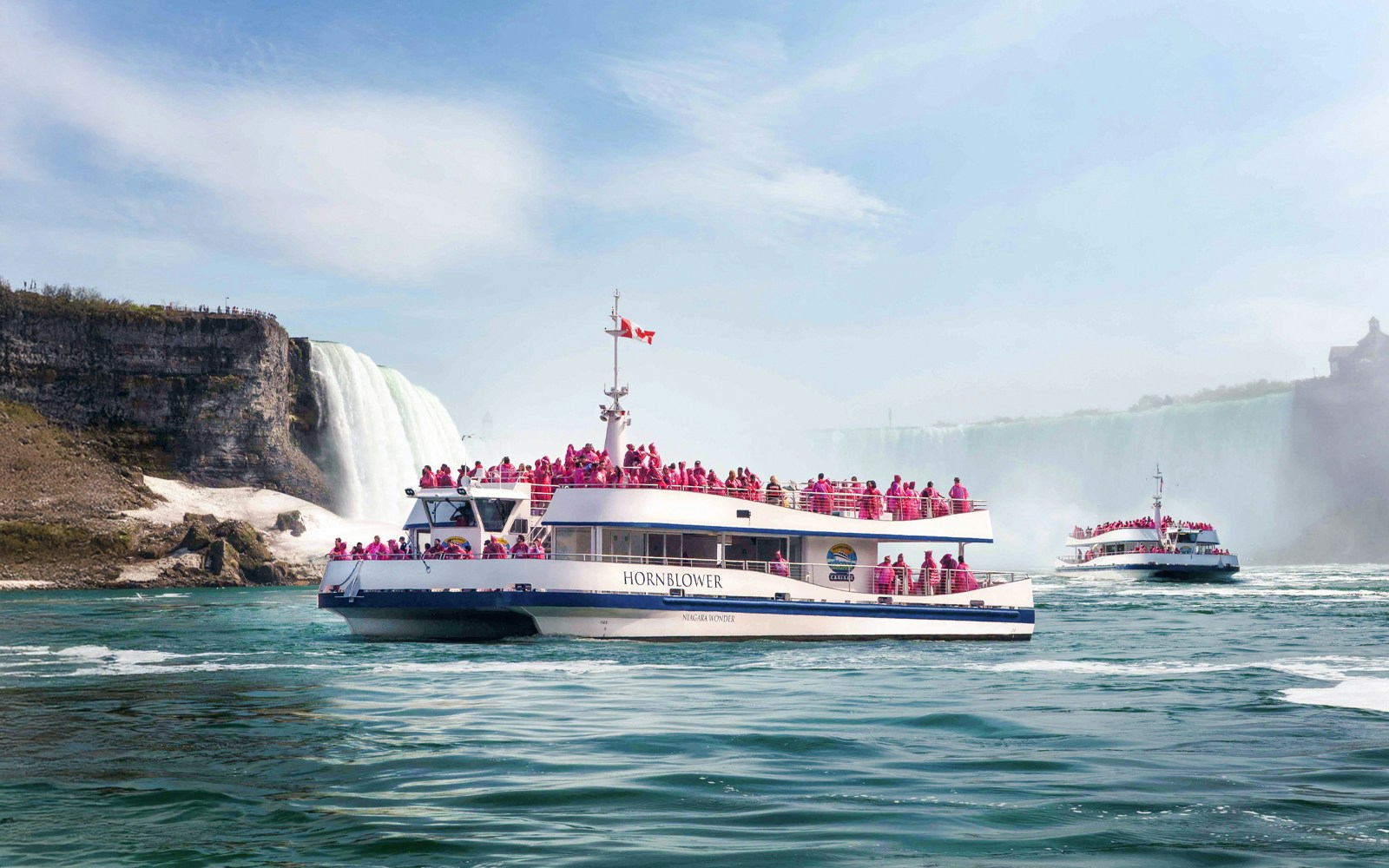 Hornblower Cruise near Niagara Falls with passengers in pink raincoats.